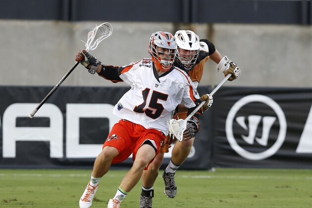 KENNESAW, GA - AUGUST 23:  Attacker Eric Law #15 of the Denver Outlaws is pursued by defender John Lade #40 of the Rochester Rattlers during the 2014 Major League Lacrosse Championship Game at Fifth Third Bank Stadium on August 23, 2014 in Kennesaw, Georgia.  (Photo by Mike Zarrilli/Getty Images)