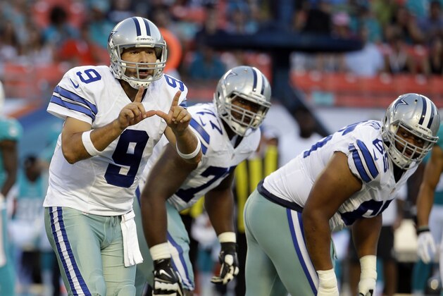 Dallas Cowboys quarterback Tony Romo (9) calls a play from the line of scrimmage during the first half of an NFL preseason football game, Saturday, Aug. 23, 2014 in Miami Gardens, Fla. (AP Photo/Lynne Sladky)