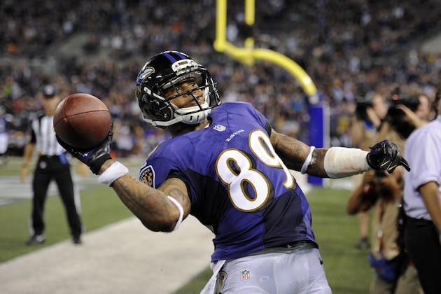 Baltimore Ravens wide receiver Steve Smith throws the ball into the stands after scoring a touchdown in the first half of an NFL preseason football game against the Washington Redskins, Saturday, Aug. 23, 2014, in Baltimore. (AP Photo/Nick Wass)