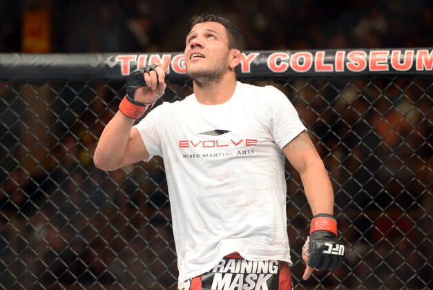 Jun 7, 2014; Albuquerque, NM, USA; Rafael Dos Anjos (red) celebrates his victory over Jason High (blue) after their lightweight bout during UFC Fight Night 42 at Tingley Coliseum. Dos Anjos won via second round stoppage. Mandatory Credit: Joe Camporeale-USA TODAY Sports