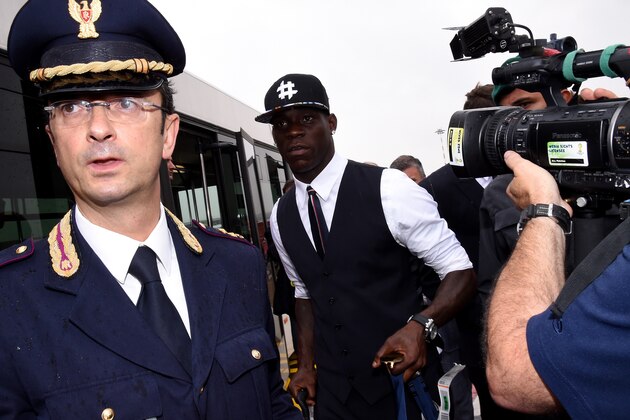 MILAN, ITALY - JUNE 26:  Mario Balotelli of Italy arrives at Malpensa Airport on June 26, 2014 in Milan, Italy.  (Photo by Claudio Villa/Getty Images)