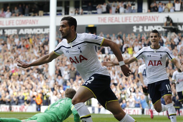Tottenham Hotspur's Nacer Chadli, left, celebrates his goal against Queens Park Rangers during their English Premier League soccer match at White Hart Lane, London, Sunday, Aug. 24, 2014. (AP Photo/Sang Tan)