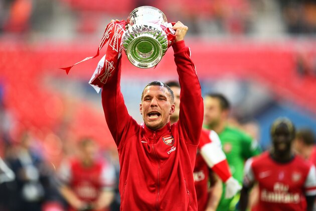 LONDON, ENGLAND - MAY 17:  Lukas Podolski of Arsenal celebrates victory with the trophy after the FA Cup with Budweiser Final match between Arsenal and Hull City at Wembley Stadium on May 17, 2014 in London, England.  (Photo by Shaun Botterill/Getty Images)