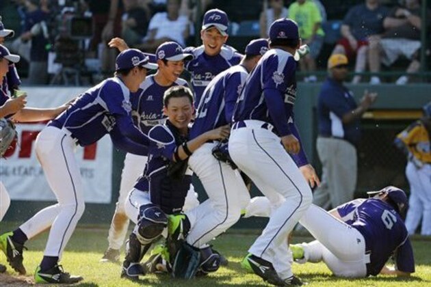 South Korea celebrate a 8-4 win over Chicago in the Little League World Series championship baseball game against Chicago in South Williamsport, Pa., Sunday, Aug. 24, 2014. (AP Photo/Gene J. Puskar)