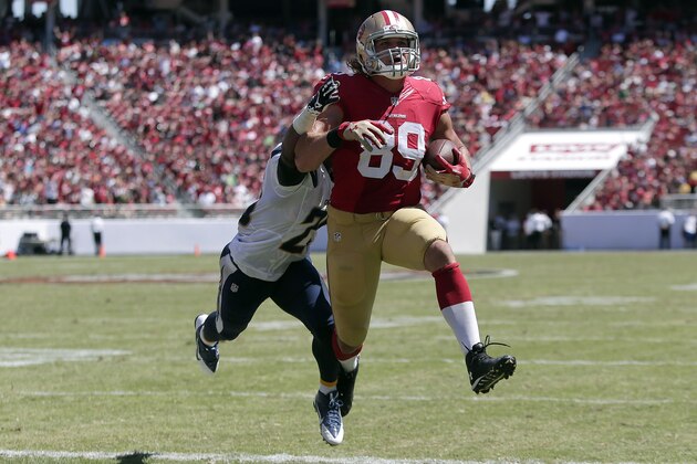 San Francisco 49ers tight end Vance McDonald (89) scores on a 6-yard touchdown reception in front of San Diego Chargers defensive back Darrell Stuckey during the second quarter of an NFL preseason football game in Santa Clara, Calif., Sunday, Aug. 24, 2014. (AP Photo/Marcio Jose Sanchez)
