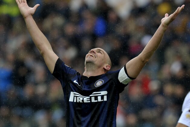 Inter Milan's Esteban Cambiasso of Argentina opens his arms during a Serie A soccer match against Parma, at Parma's Tardini stadium, Italy, Saturday, April 19, 2014. (AP Photo/Marco Vasini)