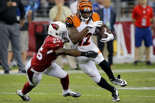 Cincinnati Bengals wide receiver Mohamed Sanu (12) runs after the catch as Arizona Cardinals cornerback Jerraud Powers (25) defends during the first half of an NFL preseason football game, Sunday, Aug. 24, 2014, in Glendale, Ariz. (AP Photo/Rick Scuteri)
