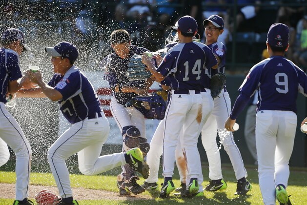 South Korea's Hae Chan Choi, top center, celebrates teammates after getting the final out of a 8-4 win in the Little League World Series championship baseball game against Chicago in South Williamsport, Pa., Sunday, Aug. 24, 2014. (AP Photo/Gene J. Puskar)