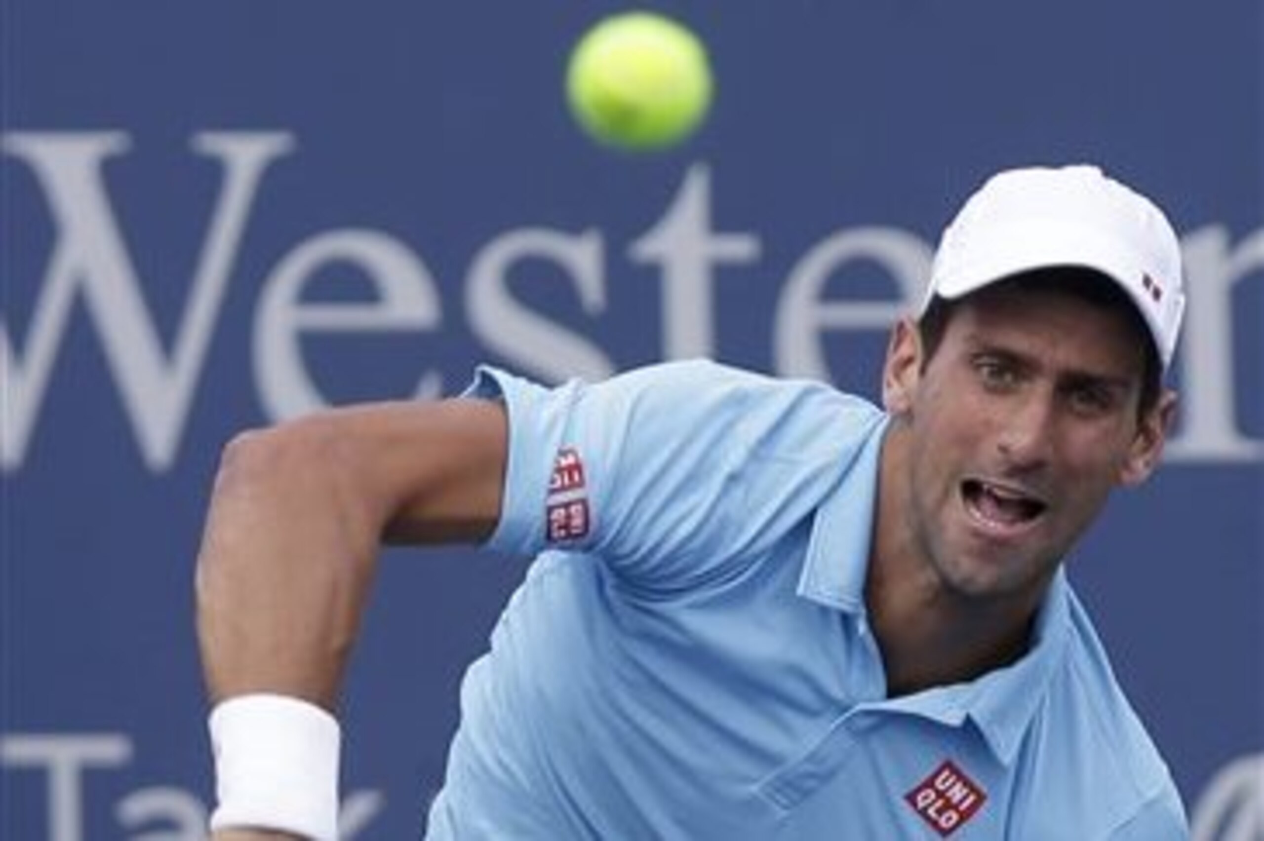 Novak Djokovic, from Serbia, serves against Tommy Robredo, from Spain, during a match at the Western & Southern Open tennis tournament, Thursday, Aug. 14, 2014, in Mason, Ohio. (AP Photo/Al Behrman)