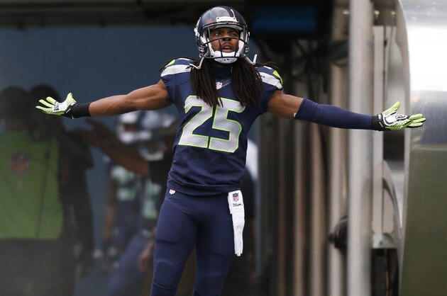 Seattle Seahawks cornerback Richard Sherman runs out of the tunnel before a preseason NFL football game against the San Diego Chargers, Friday, Aug. 15, 2014, in Seattle. (AP Photo/John Froschauer)
