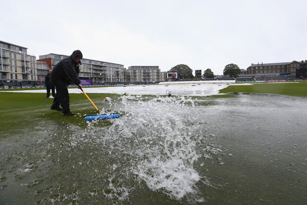 BRISTOL, ENGLAND - AUGUST 25:  Groundstaff sweep away puddles from the outfield in vain as play is abandoned in the first Royal London One-Day Series match between England and India at The County Ground on August 25, 2014 in Bristol, England.  (Photo by Michael Steele/Getty Images)