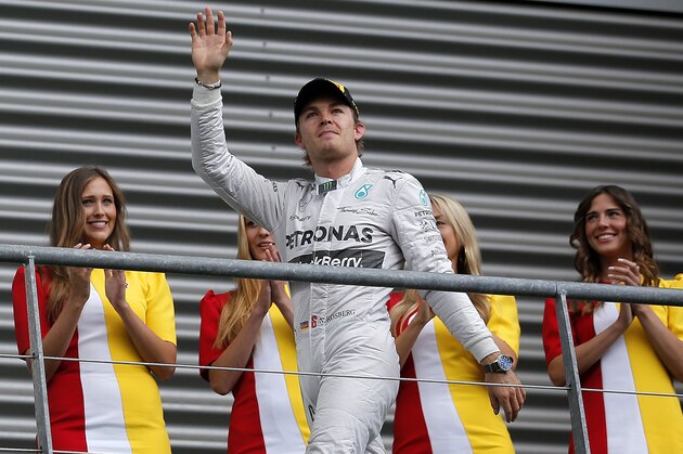 SPA, BELGIUM - AUGUST 24:  Nico Rosberg of Germany and Mercedes GP waves to the crowd as he walks on to the podium after finsihing second in the Belgian Grand Prix at Circuit de Spa-Francorchamps on August 24, 2014 in Spa, Belgium.  (Photo by Dean Mouhtaropoulos/Getty Images)