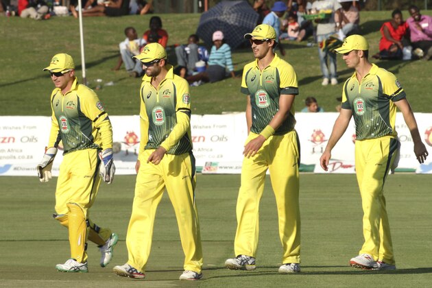 Australian cricket players walk off the pitch after winning their first ODI  cricket match against Zimbabwe at Harare Sports Club in  Harare Zimbabwe Monday, Aug. 25, 2014. The Australian team is in Zimbabwe for a triangular  ODI series with Zimbabwe and South Africa(AP Photo/Tsvangirayi Mukwazhi)