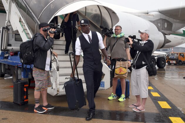 MILAN, ITALY - JUNE 26:  Mario Balotelli arrives at Malpensa Airport on June 26, 2014 in Milan, Italy.  (Photo by Claudio Villa/Getty Images)