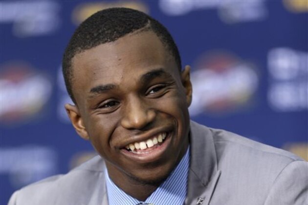 FILE - In this June 27, 2014, file photo, Cleveland Cavaliers draft pick Andrew Wiggins smiles during an NBA basketball conference in Independence, Ohio. Two people with knowledge of the deal tell The Associated Press that Minnesota and Cleveland have agreed to a trade that will send All-Star forward Kevin Love to the Cavaliers for Wiggins, Anthony Bennett and a future first-round draft pick. The two people spoke Thursday, Aug. 7, 2014, on condition of anonymity because no official agreement can be reached until Aug. 23, when Wiggins, this year's No. 1 draft pick, becomes eligible to be traded. (AP Photo/Tony Dejak, File)