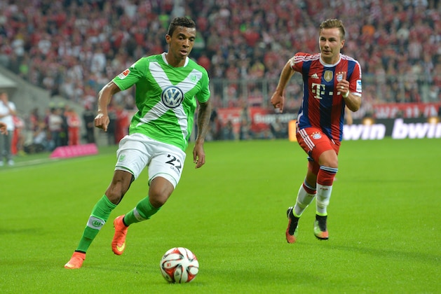 Bayern's Mario Goetze, right, and Wolfburg's Luiz Gustavo from Brazil challenge for the ball during the soccer match between FC Bayern Munich and VfL Wolfsburg in the Allianz Arena in Munich, Germany, on Friday, Aug. 22, 2014. (AP Photo/Kerstin Joensson) Bayern's Mario Goetze, right, and Wolfburg's Luiz Gustavo from Brazil challenge for the ball during the soccer match between FC Bayern Munich and VfL Wolfsburg in the Allianz Arena in Munich, Germany, on Friday, Aug. 22, 2014. (AP Photo/Kerstin Joensson)