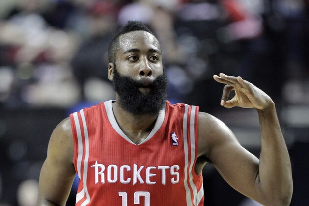Houston Rockets guard James Harden flashes three fingers after scoring a three point shot during the second half of Game 3 of an NBA basketball first-round playoff series against the Portland Trail Blazers in Portland, Ore., Friday, April 25, 2014. Harden scored 37 points as the Rockets won 121-116. (AP Photo/Don Ryan)