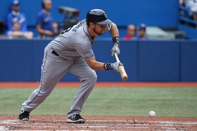 TORONTO, CANADA - AUGUST 23: Ben Zobrist #18 of the Tampa Bay Rays executes a successful suicide squeeze bunt in the third inning during MLB game action against the Toronto Blue Jays on August 23, 2014 at Rogers Centre in Toronto, Ontario, Canada. (Photo by Tom Szczerbowski/Getty Images)