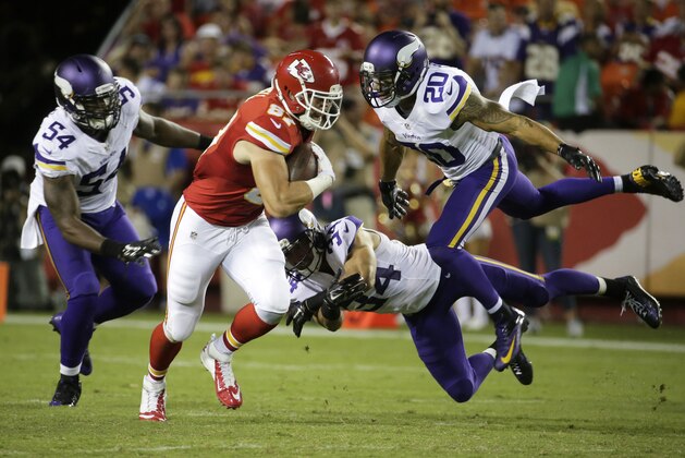 Kansas City Chiefs tight end Travis Kelce (87) runs from Minnesota Vikings safety Kurt Coleman (20), linebacker Jasper Brinkley (54) and safety Andrew Sendejo (34) during the second half of an NFL preseason football game in Kansas City, Mo., Saturday, Aug. 23, 2014. The Vikings won 30-12. (AP Photo/Charlie Riedel)
