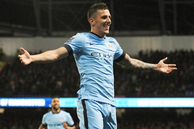 Manchester City's Stevan Jovetic celebrates after scoring his second goal against Liverpool during the English Premier League soccer match between Manchester City and Liverpool at the Etihad Stadium, in Manchester, England, Monday, Aug. 25, 2014. (AP Photo/Rui Vieira)