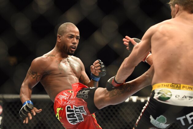 July 26, 2014; San Jose, CA, USA; Josh Thomson (red gloves) is kicked by Bobby Green (blue gloves) during the lightweight bout of the FOX UFC Saturday at SAP Center. Mandatory Credit: Kyle Terada-USA TODAY Sports
