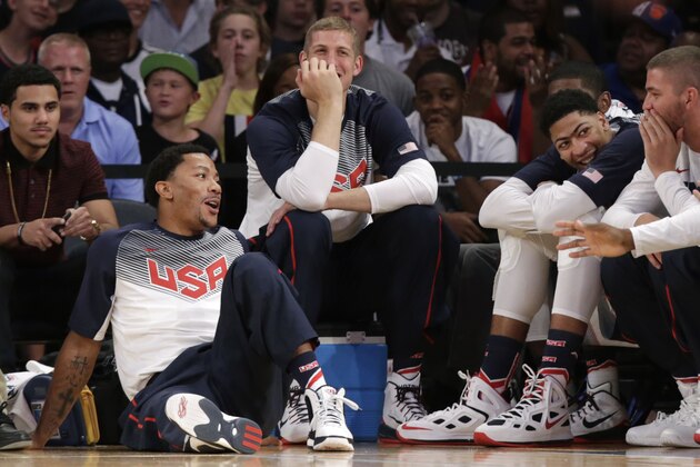 U.S. guard Derrick Rose, left, sits on the floor, next to forward Mason Plumlee and other teammates sitting on the bench during the second half of an exhibition basketball game at Madison Square Garden in New York, Wednesday, Aug. 20, 2014. Rose didn't play as the United States defeated the Dominican Republic 105-62. (AP Photo/Kathy Willens)