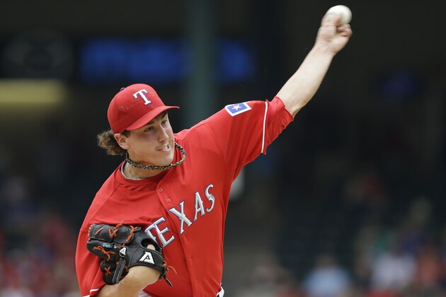 Texas Rangers starting pitcher Derek Holland (45) throws during the first inning of a baseball game against the Los Angeles Angels Saturday, Sept. 28, 2013, in Arlington, Texas.  (AP Photo/LM Otero)