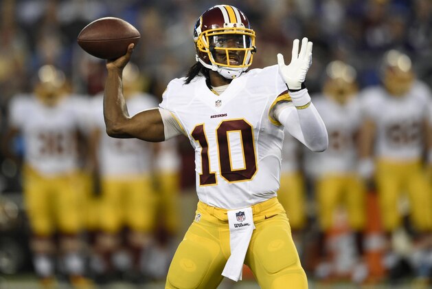 Washington Redskins quarterback Robert Griffin III throws to a receiver in the first half of an NFL preseason football game against the Baltimore Ravens, Saturday, Aug. 23, 2014, in Baltimore. (AP Photo/Nick Wass)