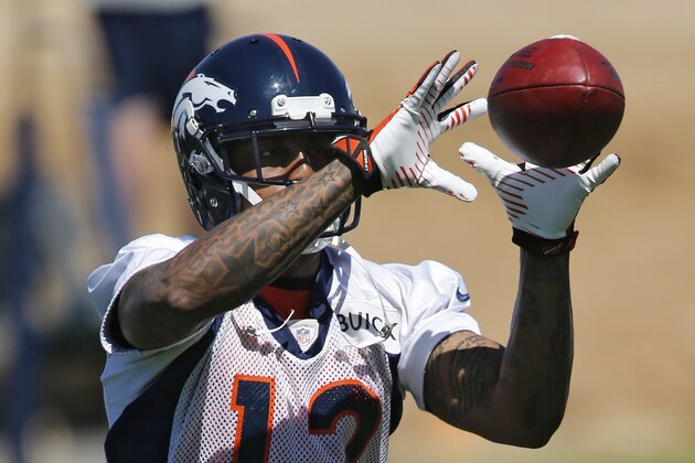 Denver Broncos wide receiver Andre Caldwell catches a pass during an NFL football organized team practice at the Broncos training facility in Englewood, Colo., on Monday, June 2, 2014. (AP Photo/Ed Andrieski)
