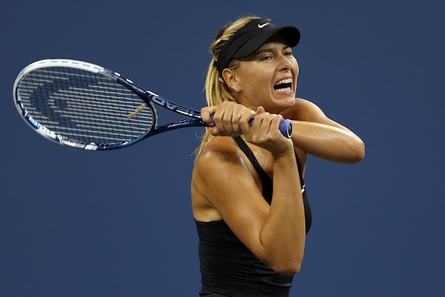 NEW YORK, NY - AUGUST 25:  Maria Sharapova of Russia returns a shot against Maria Kirilenko of Russia during her women's singles first round match on Day One of the 2014 US Open at the USTA Billie Jean King National Tennis Center on August 25, 2014  in the Flushing neighborhood of the Queens borough of New York City.  (Photo by Matthew Stockman/Getty Images)