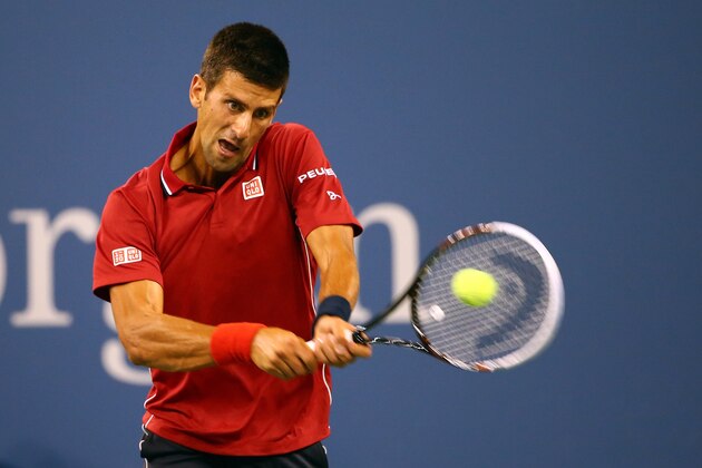 NEW YORK, NY - AUGUST 25:  Novak Djokovic of Serbia returns a shot against Diego Schwartzman of Argentina during their men's singles first round match on Day One of the 2014 US Open at the USTA Billie Jean King National Tennis Center on August 25, 2014  in the Flushing neighborhood of the Queens borough of New York City.  (Photo by Streeter Lecka/Getty Images)