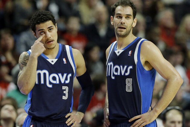 Dallas Mavericks guard Jose Calderon, right, and guard Shane Larkin look to teammates during the second half of an NBA basketball game against the Chicago Bulls in Chicago on Saturday, Dec. 28, 2013. The Mavericks won 105-83. (AP Photo/Nam Y. Huh)