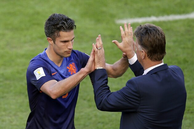 Netherlands' Robin van Persie, left, gives a high five to Netherlands' head coach Louis van Gaal after being substituted during the group B World Cup soccer match between Australia and the Netherlands at the Estadio Beira-Rio in Porto Alegre, Brazil, Wednesday, June 18, 2014.  (AP Photo/Michael Sohn)