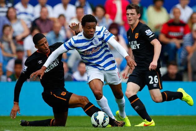 LONDON, ENGLAND - AUGUST 16:  Curtis Davies of Hull City slides in to tackle Loic Remy of Queens Park Rangers during the Barclays Premier League match between Queens Park Rangers and Hull City at Loftus Road on August 16, 2014 in London, England.  (Photo by Steve Bardens/Getty Images)
