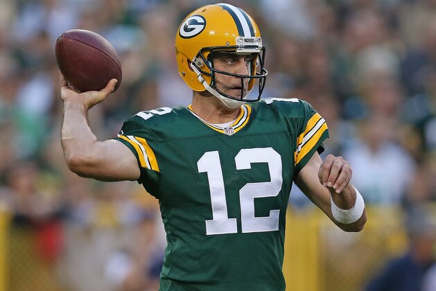 GREEN BAY, WI - AUGUST 22:  Quarterback Aaron Rodgers #12 of the Green Bay Packers looks to pass during the first quarter of a preseason game against the Oakland Raiders at Lambeau Field on August 22, 2014 in Green Bay, Wisconsin. The Packers defeated the Raiders 31-21.  (Photo by Jonathan Daniel/Getty Images)
