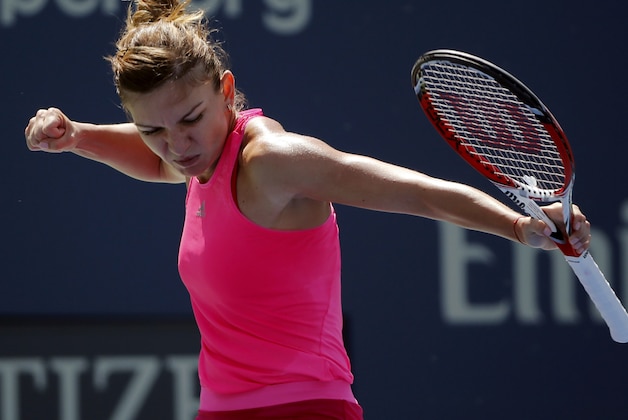 Simona Halep, of Romania, reacts after a shot against Danielle Rose Collins, of the United States, in the first round during the opening round of the 2014 U.S. Open tennis tournament, Monday, Aug. 25, 2014, in New York. (AP Photo/Elise Amendola)