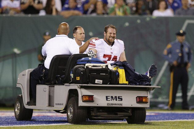 New York Giants guard Geoff Schwartz (74) is carted off the field after an injury in the second quarter against the New York Jets during a preseason NFL football game, Friday, Aug. 22, 2014, in East Rutherford, N.J. (AP Photo/Julio Cortez)
