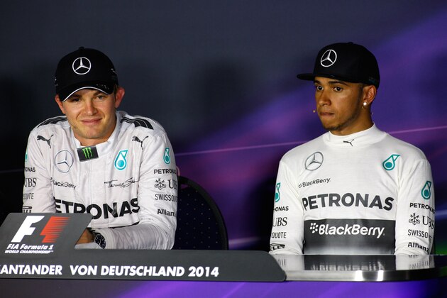 HOCKENHEIM, GERMANY - JULY 20:  Nico Rosberg of Germany and Mercedes GP smiles next to Lewis Hamilton of Great Britain and Mercedes GP during the drivers' press conference after victory in the German Grand Prix at Hockenheimring on July 20, 2014 in Hockenheim, Germany.  (Photo by Drew Gibson/Getty Images)