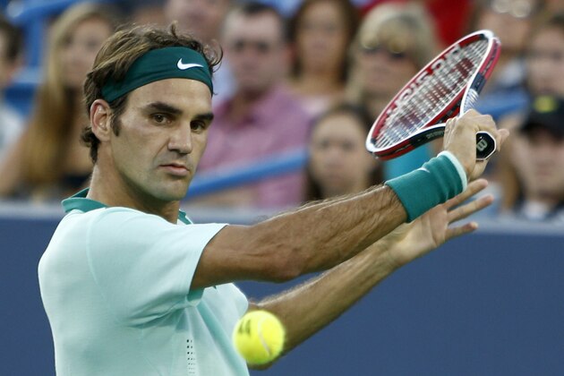 Roger Federer, from Switzerland, returns a volley to Gael Monfils, from France, during a match at the Western & Southern Open tennis tournament, Thursday, Aug. 14, 2014, in Mason, Ohio. (AP Photo/David Kohl)