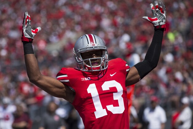 Apr 12, 2014; Columbus, OH, USA; Ohio State scarlet team cornerback Eli Apple (13) celebrates his squad's first-quarter touchdown during the Ohio State Buckeyes spring game at Ohio Stadium. The scarlet team won the game 17-7. Mandatory Credit: Greg Bartram-USA TODAY Sports