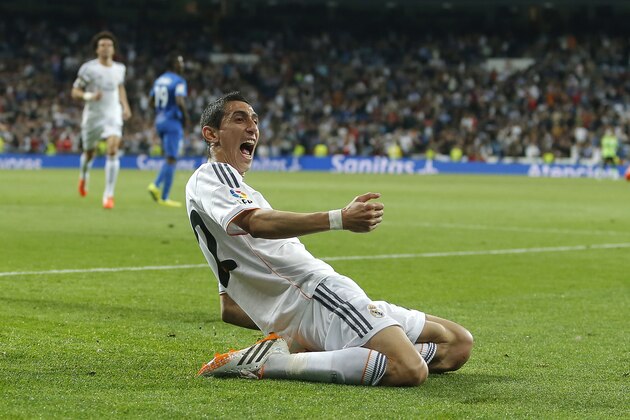 Real Madrid's Angel Di Maria, center, celebrates his goal during a Spanish La Liga soccer match against Almeria at the Santiago Bernabeu stadium in Madrid, Spain, Saturday, April 12, 2014. (AP Photo/Andres Kudacki)
