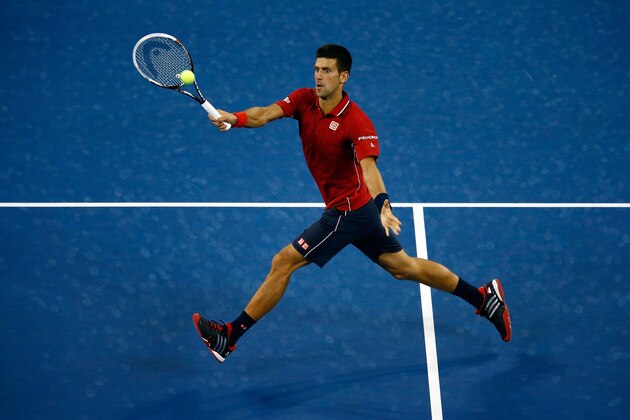 NEW YORK, NY - AUGUST 25:  Novak Djokovic of Serbia returns a shot against Diego Schwartzman of Argentina during their men's singles first round match on Day One of the 2014 US Open at the USTA Billie Jean King National Tennis Center on August 25, 2014  in the Flushing neighborhood of the Queens borough of New York City.  (Photo by Julian Finney/Getty Images)