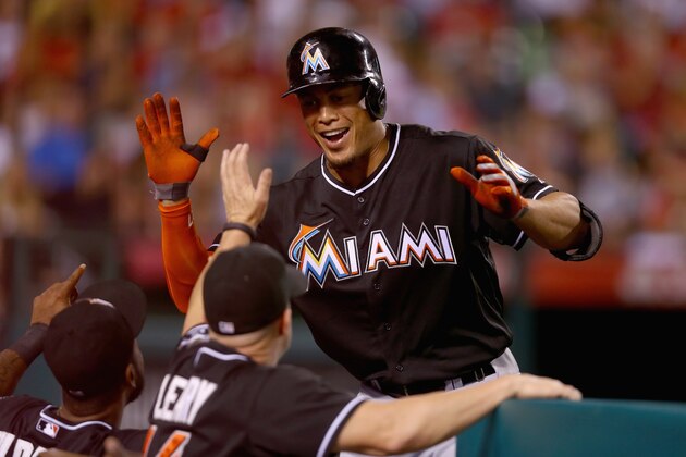 ANAHEIM, CA - AUGUST 25:  Giancarlo Stanton #27 of the Miami Marlins receives high fives in the dugout after hitting a three-run home run against the Los Angeles Angels of Anaheim in the fourth inning at Angel Stadium of Anaheim on August 25, 2014 in Anaheim, California.  (Photo by Jeff Gross/Getty Images)