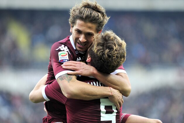 Torino forward Ciro Immobile, back to camera, celebrates with teammate Alessio Cerci after scoring during a Serie A soccer match between Torino and Chievo Verona at the Olympic stadium, in Turin, Italy, Sunday, Dec. 22, 2013. (AP Photo/Massimo Pinca)