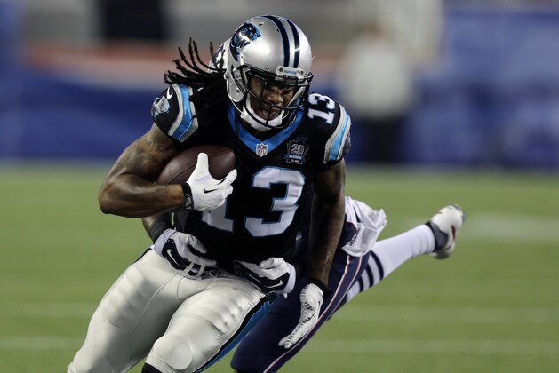 New England Patriots cornerback Darrelle Revis, rear, tries to wrap up Carolina Panthers wide receiver Kelvin Benjamin (13) in the first half of an NFL preseason football game Friday, Aug. 22, 2014, in Foxborough, Mass. (AP Photo/Charles Krupa)