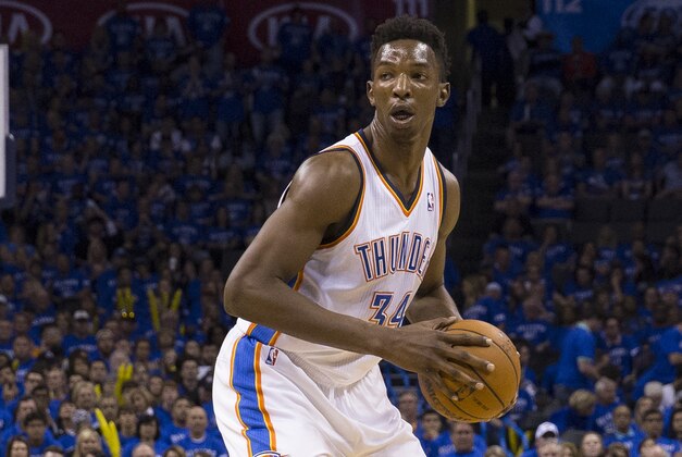 OKLAHOMA CITY, OK - May 25: Hasheem Thabeet #34 of the Oklahoma City Thunder handles the ball against the San Antonio Spurs in Game 3 of the Western Conference Finals during the 2014 NBA Playoffs at the Chesapeake Arena on May 25, 2014 in Oklahoma City, Oklahoma. NOTE TO USER:  User expressly acknowledges and agrees that, by downloading and/or using this photograph, user is consenting to the terms and conditions of the Getty Images License Agreement. Mandatory Copyright Notice:  Copyright 2014 NBAE (Photo by Richard Rowe/NBAE via Getty Images)