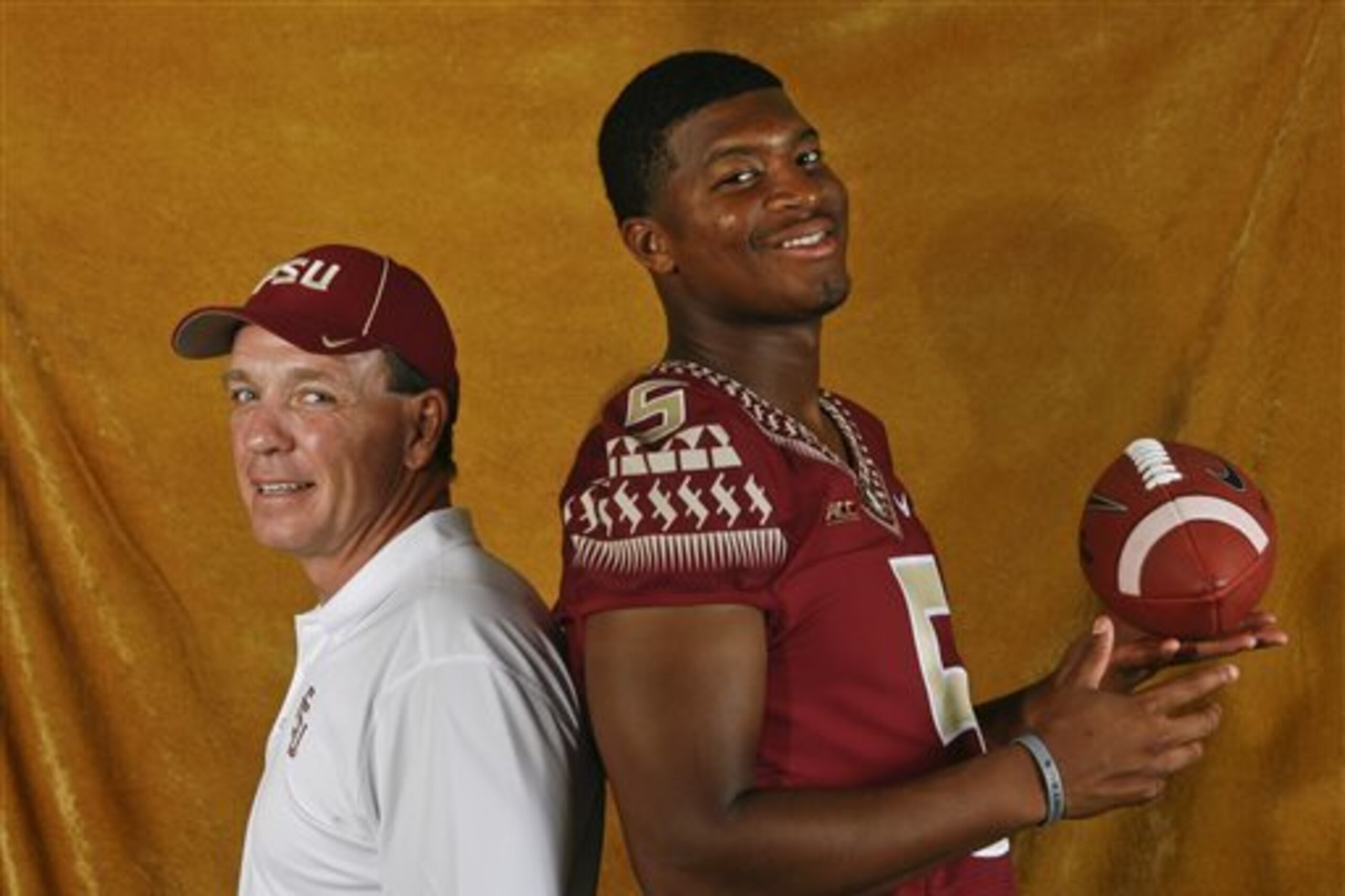FILE - In this Aug. 10, 2014, file photo, Florida State head coach Jimbo Fisher, left, and quarterback Jameis Winston (5) pose for a photo during their NCAA college football media day in Tallahassee, Fla. Fisher may be the pre-eminent quarterback coach in college football. He has had eight quarterbacks drafted to the NFL since 2001, works with reigning Heisman winner Jamies Winston and two of his former Seminole disciples are expected to start for other major college programs this year. (AP Photo/Phil Sears, File)