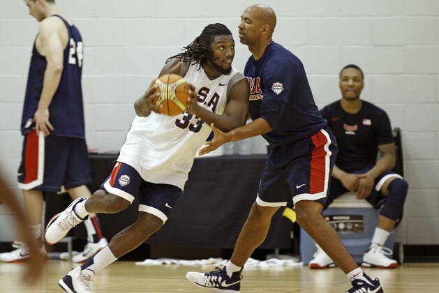 USA Basketball forward/center Anthony Davis of the New Orleans Jazz, left,  watches teammate Kenneth Faried of the Denver Nuggets post up during a team practice at the Brooklyn Nets training facility in East Rutherford, N.J., Tuesday, Aug. 19, 2014. Team USA faces the Dominican Republic in an exhibition game Wednesday at Madison Square Garden in New York in preparation for the FIBA World Cup tournament Aug. 30-Sept. 14 in Spain. (AP Photo/Kathy Willens)
