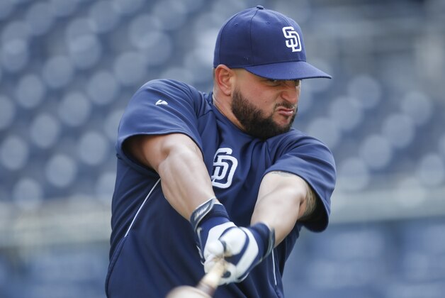 San Diego Padres first baseman Yonder Alonso, who is hitting a fourth best in the majors leagues at .421 since the all-star break, swings a weight batted getting lose during pre-game activity prior to a baseball game against the Colorado Rockies Tuesday, Aug. 12, 2014, in San Diego. (AP Photo/Lenny Ignelzi)