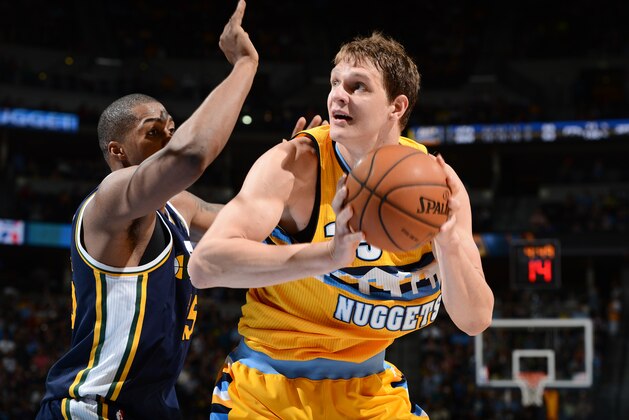 DENVER, CO - APRIL 12: Timofey Mozgov #25 of the Denver Nuggets handles the ball against the Utah Jazz on April 12, 2014 at the Pepsi Center in Denver, Colorado. NOTE TO USER: User expressly acknowledges and agrees that, by downloading and/or using this Photograph, user is consenting to the terms and conditions of the Getty Images License Agreement. Mandatory Copyright Notice: Copyright 2014 NBAE (Photo by Garrett W. Ellwood/NBAE via Getty Images)